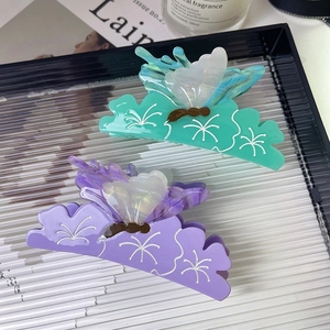 Elegant butterfly acetate hair claws in purple and green gradients with floral textures