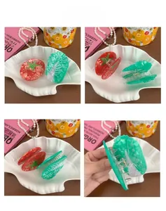 Detail view of tomato and vegetable acetate hair claws with premium metal spring structure