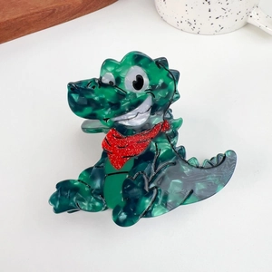 Close-up of cute green crocodile hair claw clip made of marble texture acetate