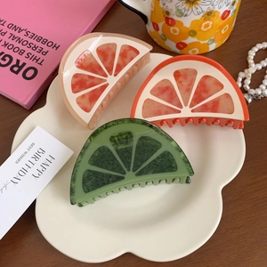 Chic acetate fruit-shaped claw clips in orange and lime designs for elegant hairstyles