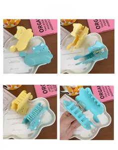 Detailed views of cat-shaped acetate hair claws in yellow and blue with metal springs