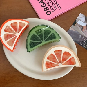 Three-piece acetate hair claw clips set with orange lime and grapefruit fruit designs