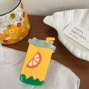 Detail of creative juice box hair claw clip with colorful summer fruit pattern