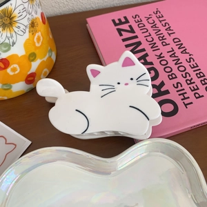 Detailed view of a cute white cat acetate hair claw clip with pink inner ears decoration