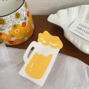 Close-up of creative beer mug hair claw clip with yellow liquid and white foam details