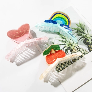 Three large acrylic hair claws with cherry, rainbow and pink heart patterns