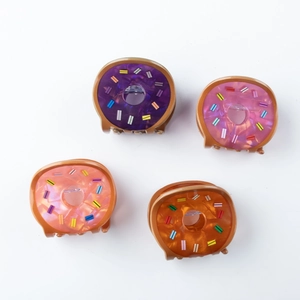 Detailed macro of acetate donut hair claws with colorful candy sprinkle patterns