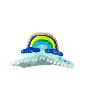 Translucent blue rainbow hair claw clip with colorful cloud print and Rainbow text detail