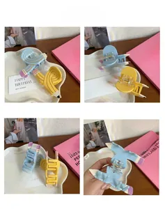 Detailed views of creative pencil-shaped hair claw clips in blue and yellow colors