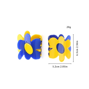Detailed view of floral hair claws in blue and yellow showing 6.5cm size dimensions