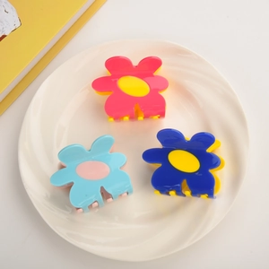 Three-piece floral acetate hair claws set in vibrant pink, blue, and yellow summer colors