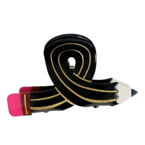 Creative pencil-shaped hair claw clip in glossy black finish with gold glitter stripes