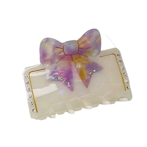 Pince à cheveux nœud élégante avec finition résine violette et jaune et diamants