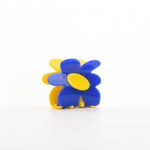 Floral acetate hair claw clip with blue and yellow petals for elegant hair styling