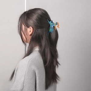 Chic blue unicorn acetate hair claw clip with colorful star patterns and orange horn
