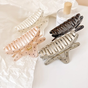 Star shaped pearlescent hair claws with polka dots in assorted elegant colors