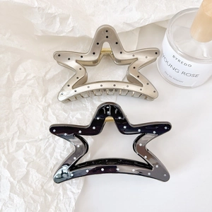 Star shaped hair claw clips with pearlescent finish and dotted pattern set of two