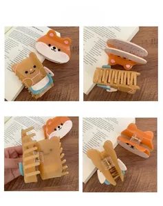 Detail view of cute acetate hair clips with Corgi and bear designs and metal springs