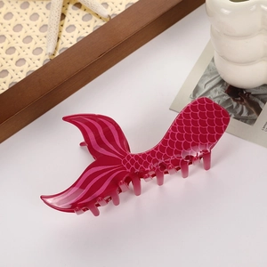 Detail of rose red mermaid tail hair claw clip with scale texture and fin design