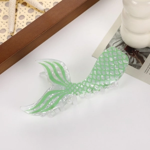 Close-up of translucent green fishtail hair claw clip with delicate fish scale texture