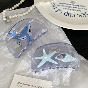 Set of two ocean themed shark hair clips featuring blue whale and starfish patterns