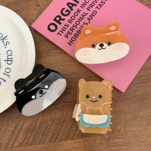 Cute acetate hair claws with cartoon animals like corgi and bear on wooden background