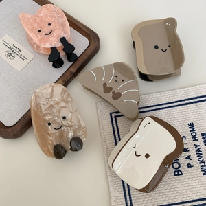 Chic croissant and toast shaped acetate hair claws set with minimalist smiley faces