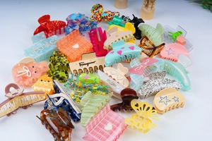 Detailed view of assorted large acetate hair claws with checkered and heart patterns