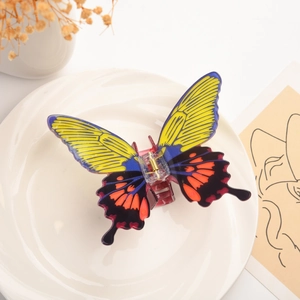 Macro shot of colorful butterfly hair claw clip with vibrant patterns on ceramic plate