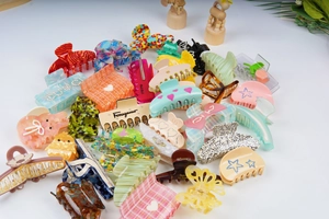 Detailed close-up showing a variety of colorful acrylic hair clips with diverse patterns