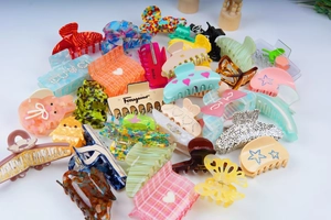 Assorted acetate hair claws featuring leopard print and glitter stars in bulk display