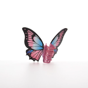 Detail of butterfly hair claw with pink blue gradient wings and pearlescent glitter texture