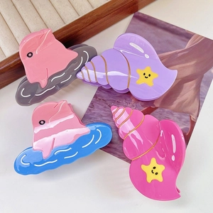 Set of 4 ocean themed acetate hair claws featuring dolphin and shell shapes in vibrant colors