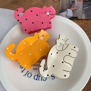 Cute cartoon cat hair claws in pink, orange, and white with polka dot acetate patterns