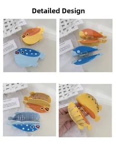 Detailed views of puffer fish hair claws in blue and orange acetate with metal spring