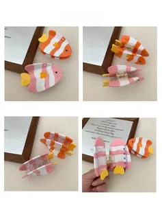 Detail of cute clownfish hair claws with transparent teeth and strong metal spring