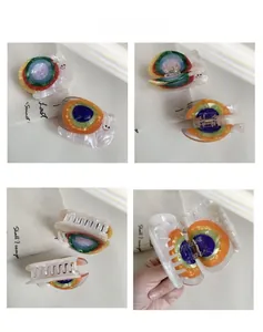 Detail view of colorful snail hair claw clip with golden metal spring and multi-color texture