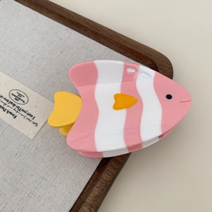 Detail view of pink and yellow tropical fish hair claw clip made of acetate fiber