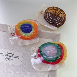Three cute acetate rainbow snail hair claws in leopard and colorful patterns