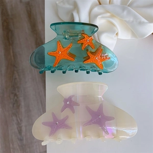 Blue and white acetate starfish claw clips set with sparkling rhinestones for women
