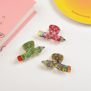 Detailed view of colorful pencil-shaped shark hair clips with unique marble textures