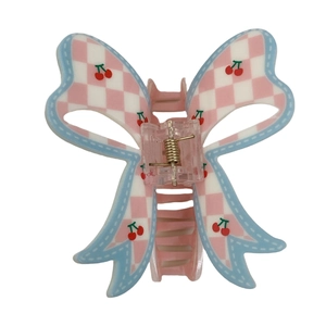 Pink and white checkered butterfly hair claw clip with cherry patterns and blue borders