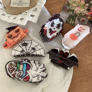Collection of Halloween hair claws featuring pumpkin, ghost, and spider motifs for women
