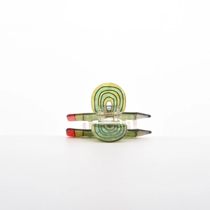 Detail shot of a creative pencil-shaped hair claw clip with colorful striped design