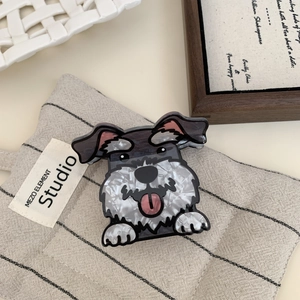 Detail view of Schnauzer hair claw clip with acetate texture on soft fabric background