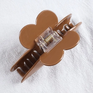 Brown floral hair claw clip with heart diamond accents and durable spring in main view