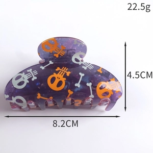 Detail showing an 8.2cm purple Halloween skeleton hair claw clip with size measurements