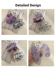 Detail shot of Halloween hair claws featuring witch hat and ghost designs in acrylic texture