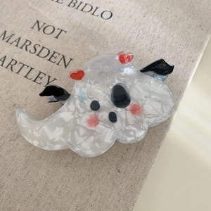 Detail of a cute ghost hair claw clip made of white marble texture acrylic with red hearts