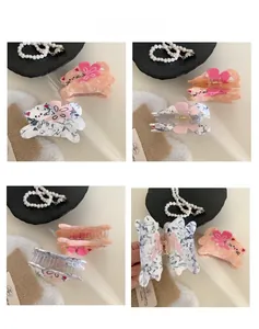 Detailed views of cat-shaped hair claw clips with marble texture and floral accents